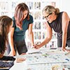 three people busy at work