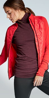 woman wearing foresthill top and red insulated jacket