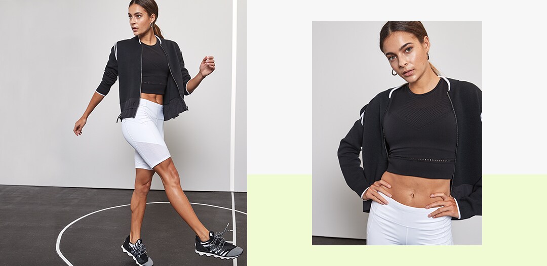 woman wearing white contender biker shorts, crop tank top and black jacket
