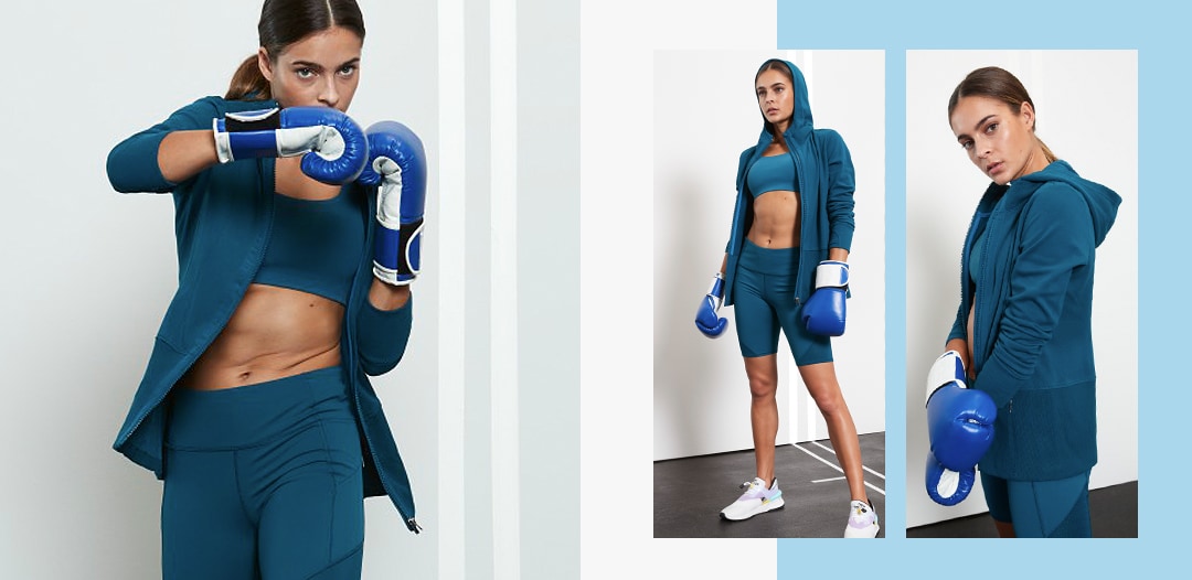 woman wearing all teal, tights, bra and jacket
