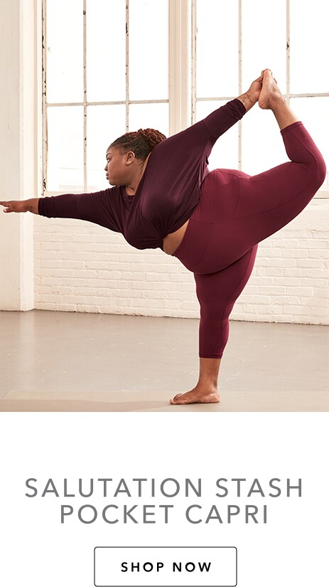 woman doing a scorpion in the maroon salutation stash pocket capri