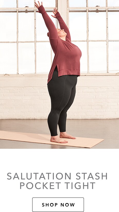 woman stretching in black salutation stash pocket tight