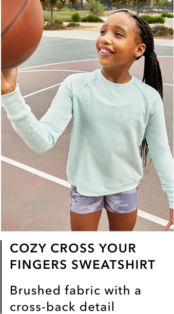 girl wearing light green/mint Cozy Cross Your Fingers Sweatshirt: Brushed fabric with a cross-back detail.
