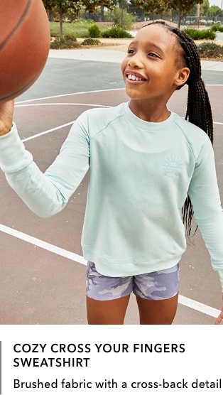 girl wearing light green/mint Cozy Cross Your Fingers Sweatshirt: Brushed fabric with a cross-back detail.