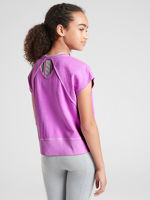 1 of 8 showing, with the color Purple Flourish Neon of product Athleta Girl Beachy Open Back Sweatshirt