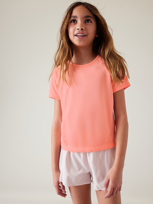 1 of 8 showing, with the color Tropical Peach of product Athleta Girl Power Up Seamless Sport Length Tee