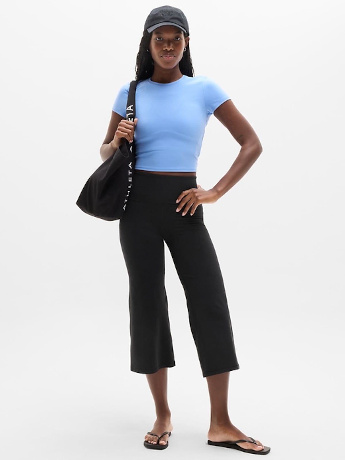 Woman wearing Athleta Elation high rise crop flare pant
